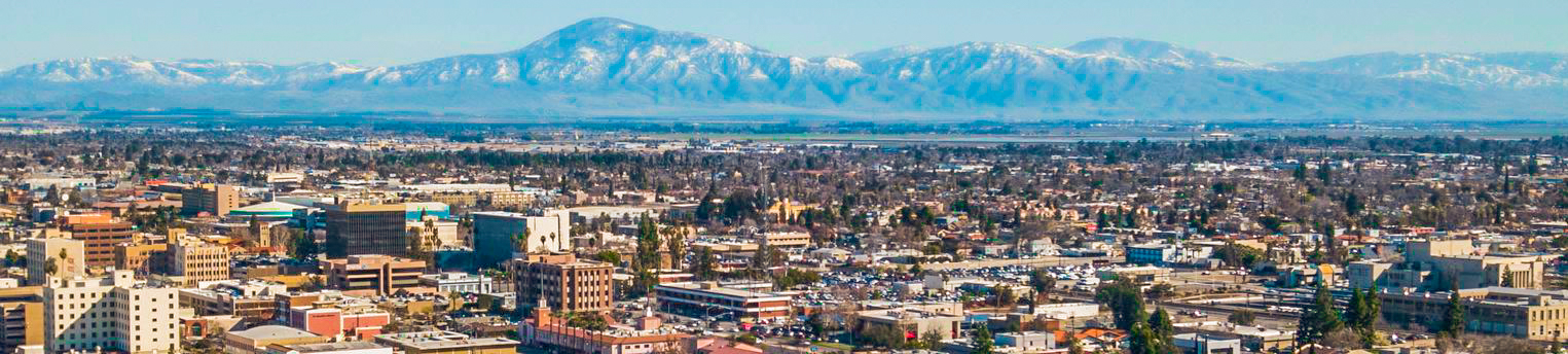 Image of Downtown Bakersfield with snow capped peaks